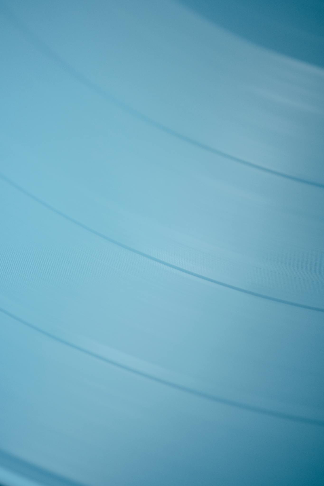 A minimalist close-up of blue vinyl texture, ideal for artistic backgrounds.