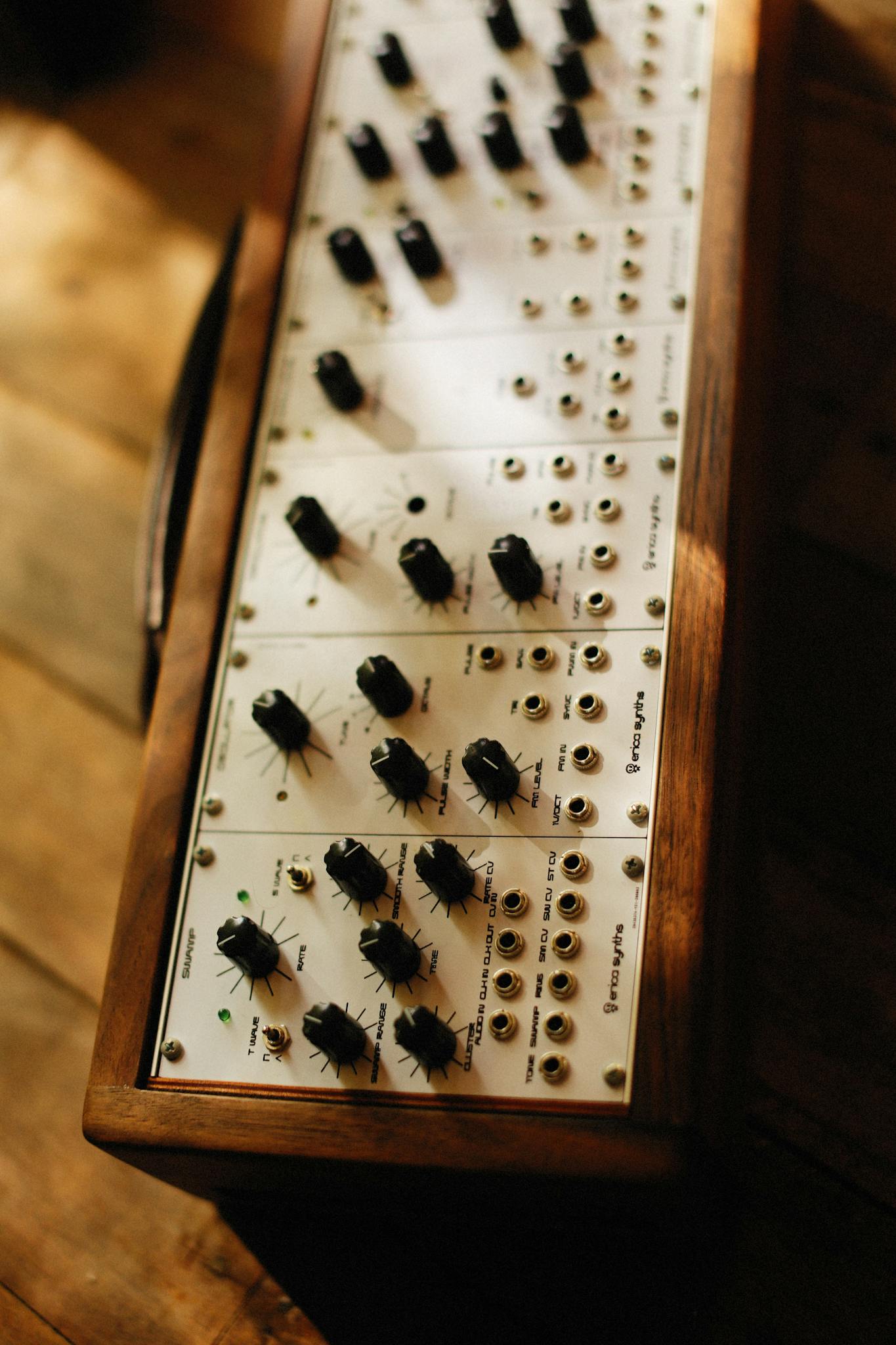 Close-up of a vintage music mixer showcasing analog knobs and wood finish.